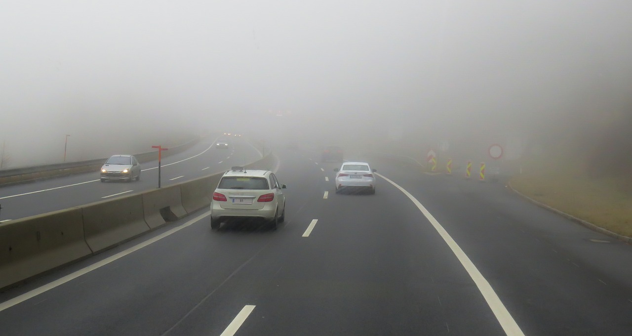 Cars driving on a foggy road