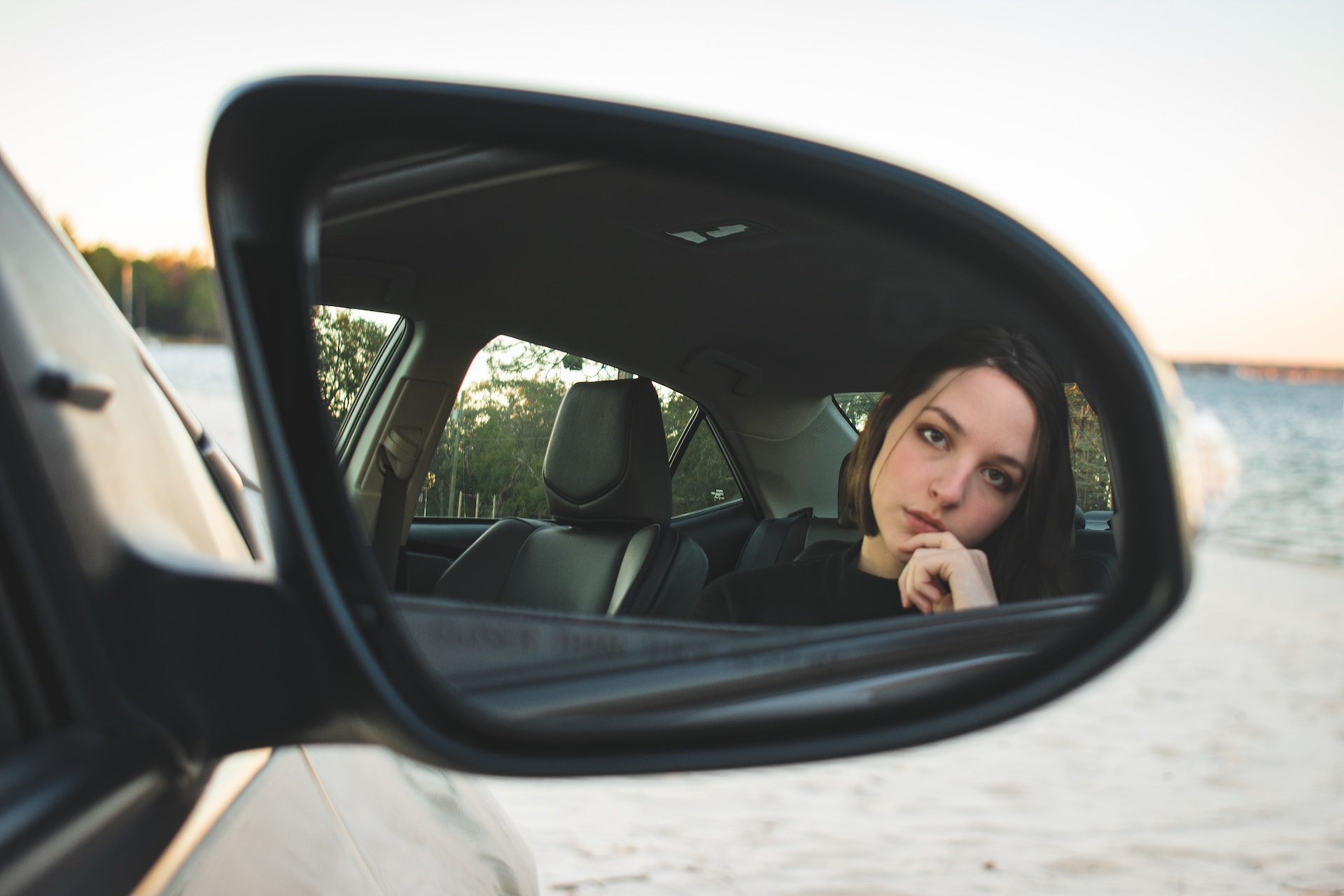 Girl in car mirror