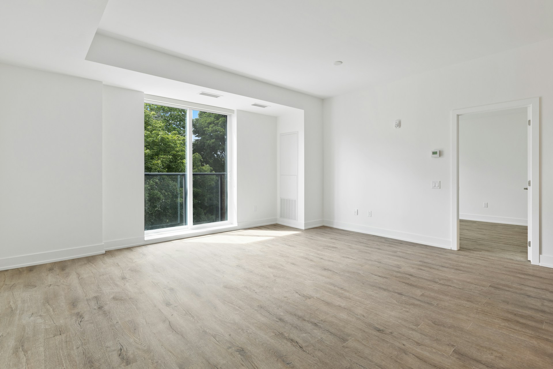 empty apartment with white wooden framed glass window wood floor